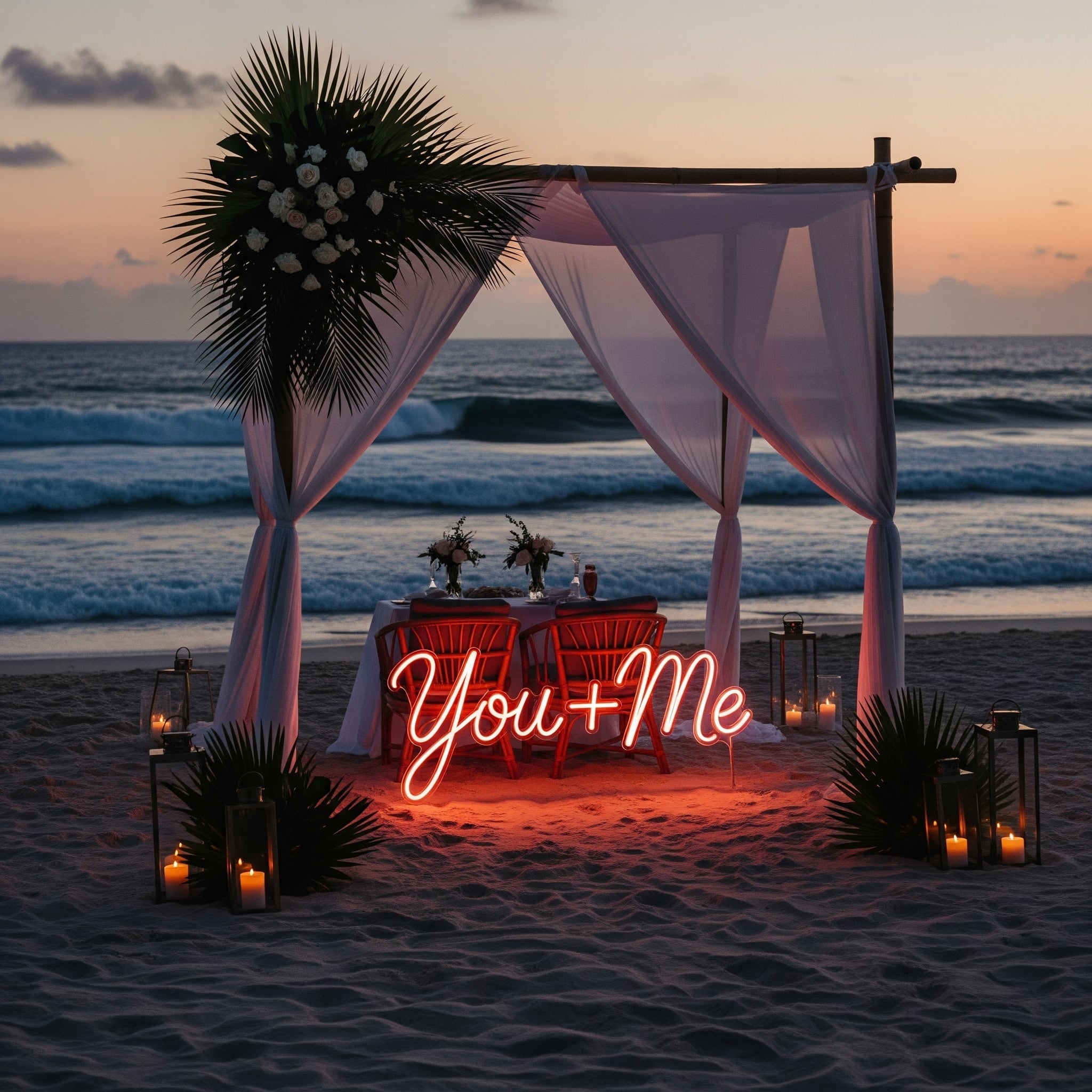 Romantic beachside table with 'You + Me' neon sign and sunset view